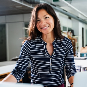 Woman smiling while at her office workspace.