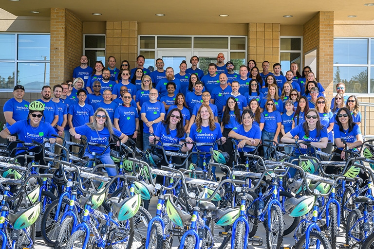 Bamboo Insurance employees posing outside during their Wish for Wheels volunteering event.