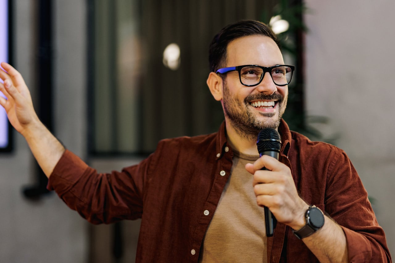 Male speaker delivering a talk during a presentation.