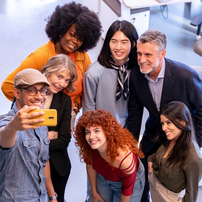 Smiling coworkers standing together and posing for a photo.