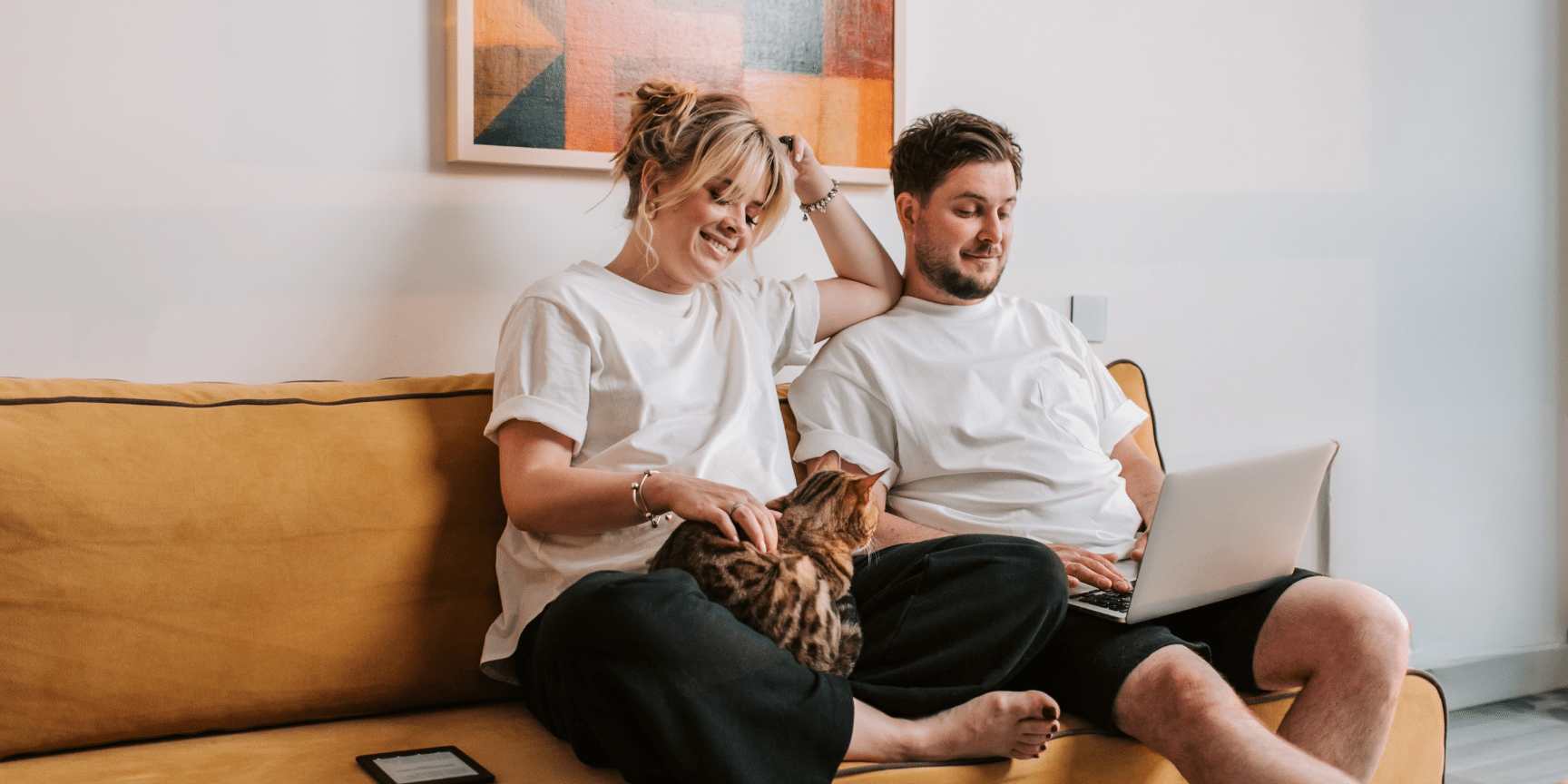 A couple on a couch at home looking at insurance options at Bamboo Insurance.
